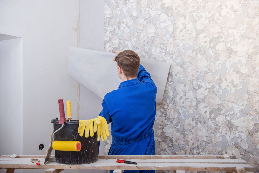 Professional wallpaper installer at work